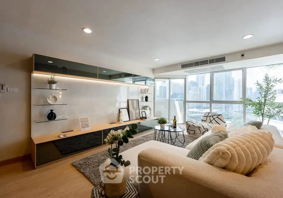 Luxurious modern living room with city view, elegant decor, and abundant natural light.