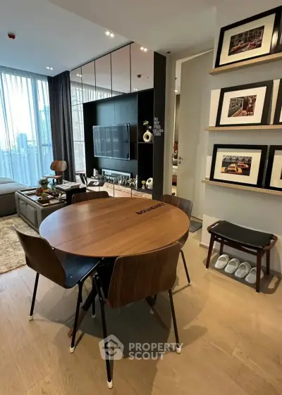 Modern living room with stylish dining area and wall art, featuring a cozy ambiance and contemporary design.