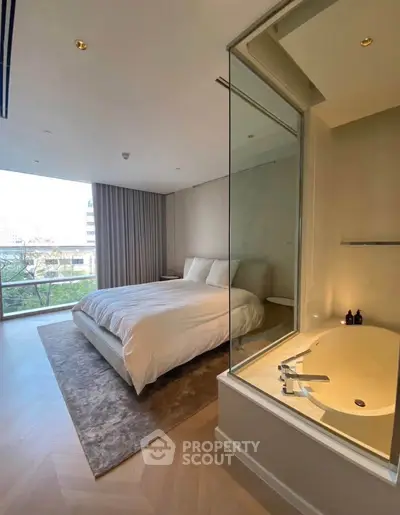 Luxurious bedroom with modern bathtub and stunning city view, perfect for urban living.