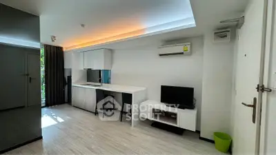Modern studio apartment with sleek kitchen and cozy living area, perfect for urban living.