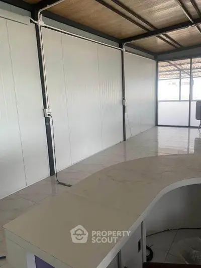 Spacious modern office interior with sleek design and ample natural light.
