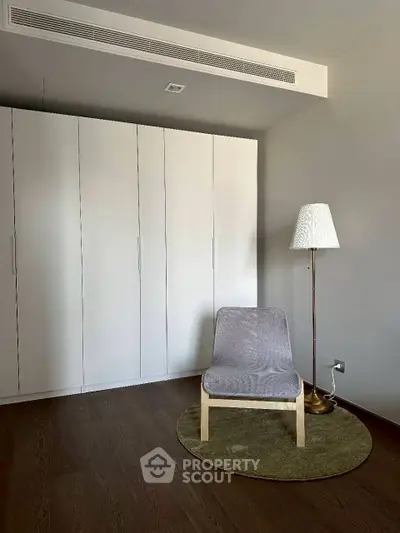 Minimalist bedroom with modern chair and floor lamp