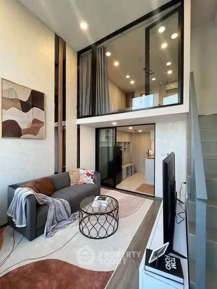 Modern loft-style living room with high ceilings and stylish decor
