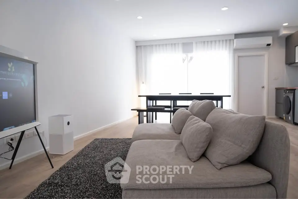 Spacious modern living room with cozy sofa and natural light