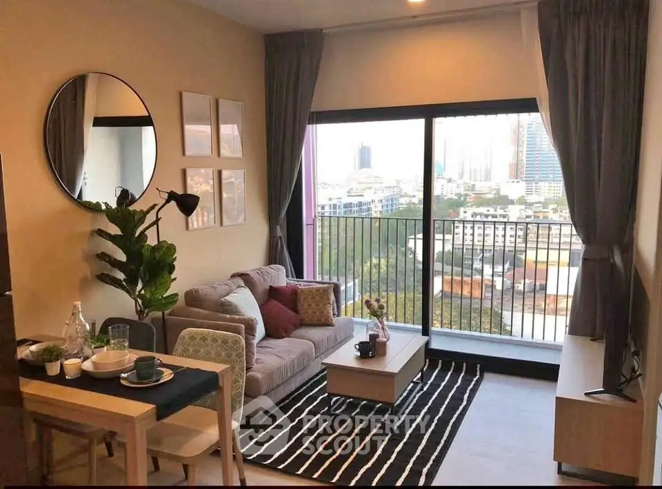 Modern living room with city view, stylish decor, and cozy seating area.