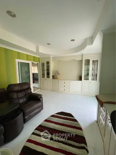 Spacious living room with elegant built-in cabinets and cozy seating area.