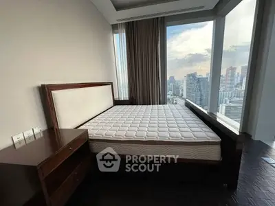 Luxurious bedroom with stunning city view and elegant wooden furniture