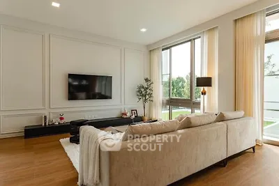Spacious modern living room with large windows and elegant decor