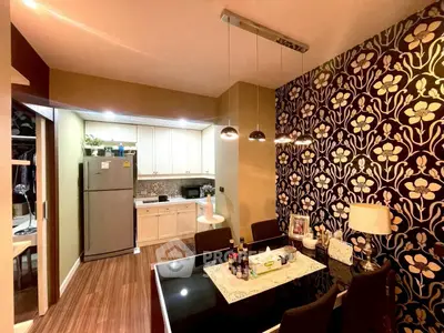Stylish dining area with modern kitchen and floral accent wall
