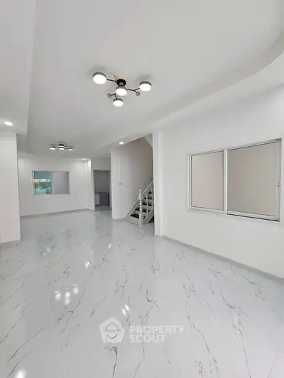 Spacious modern interior with elegant lighting and marble flooring, ideal for contemporary living.