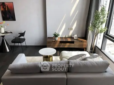 Modern living room with stylish furniture and large window view