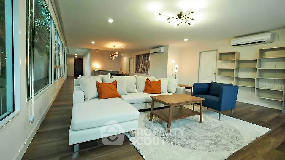 Spacious modern living room with elegant decor and large windows