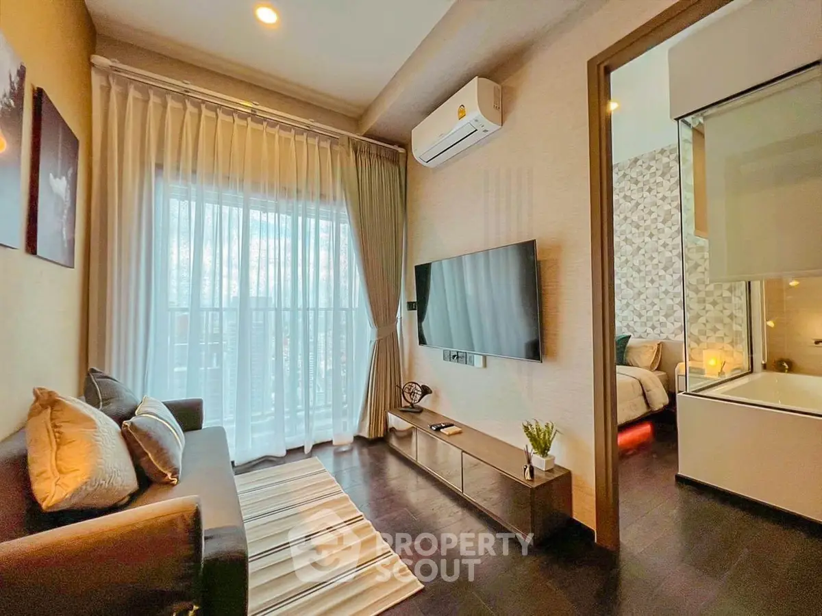 Modern living room with cozy sofa, wall-mounted TV, and elegant decor in a stylish apartment.