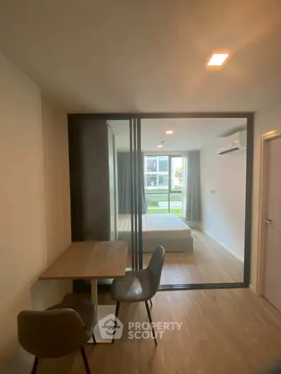 Modern studio apartment with glass partition and cozy furnishings