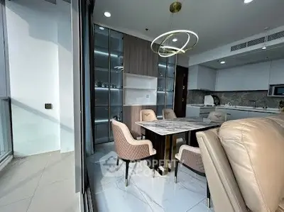 Modern dining area with elegant chairs and marble table in open kitchen layout