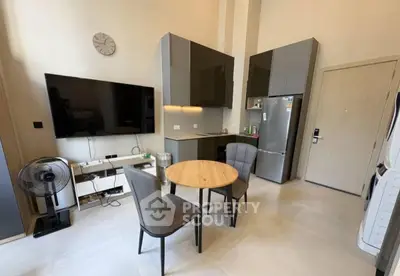 Modern kitchen with sleek cabinets and dining area in stylish apartment