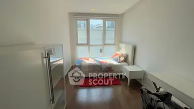 Bright and cozy bedroom with modern furnishings and large windows in a stylish apartment.