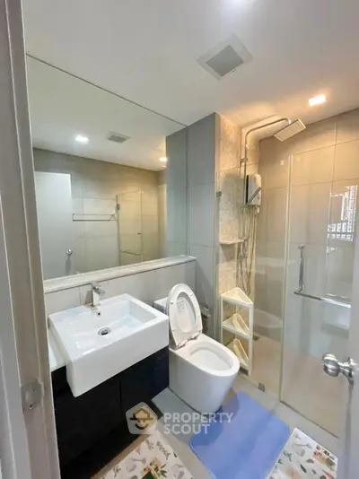 Modern bathroom with sleek fixtures and glass shower enclosure