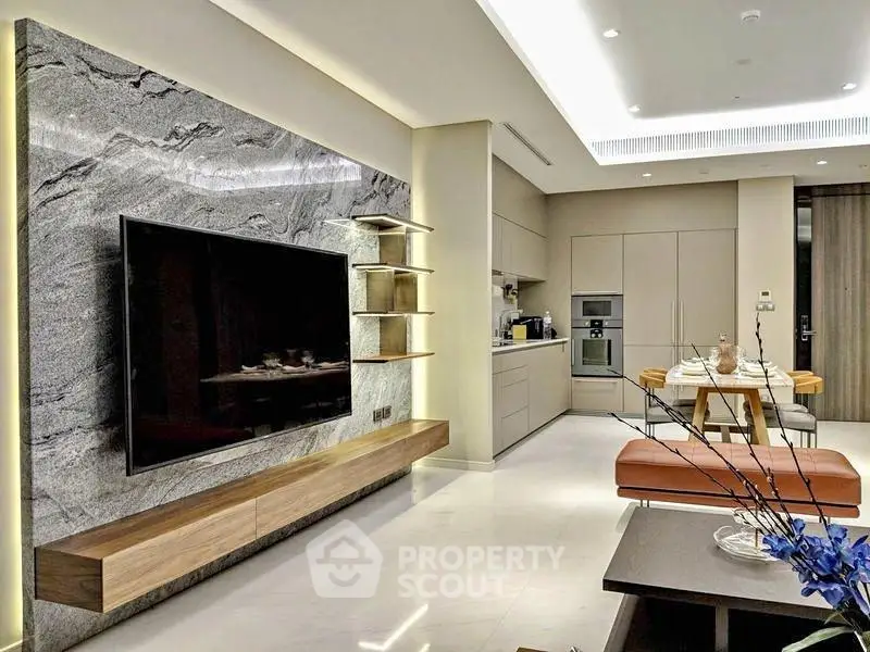 Luxurious modern living room with open kitchen, featuring sleek design and elegant furnishings.