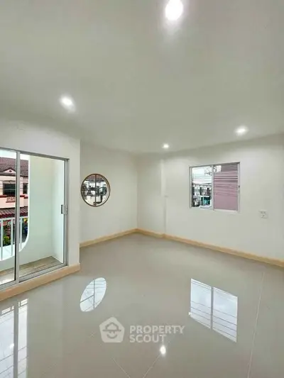 Spacious and bright living room with balcony access and modern finishes.
