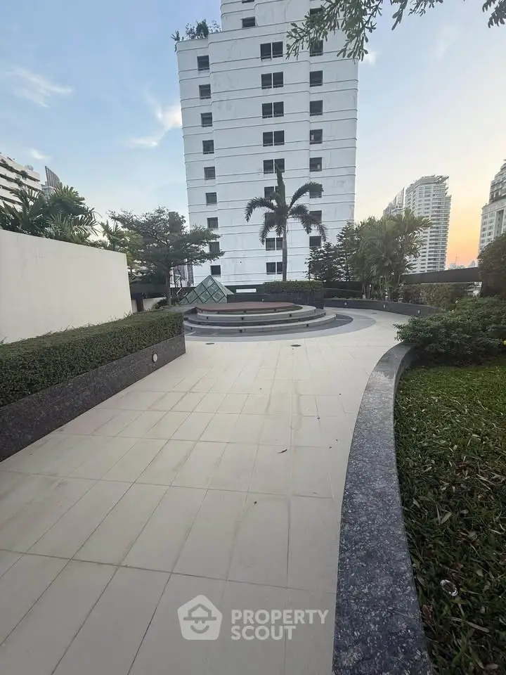 Modern apartment building with landscaped garden and spacious walkway