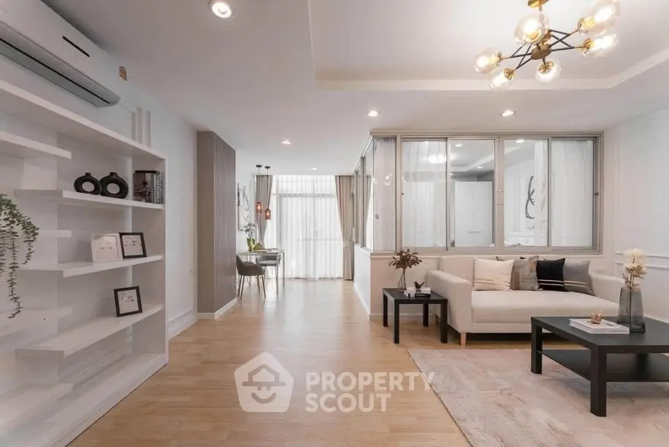Spacious modern living room with elegant decor and natural light.