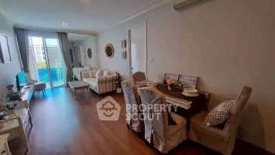Spacious living room with elegant dining area and large windows for natural light.