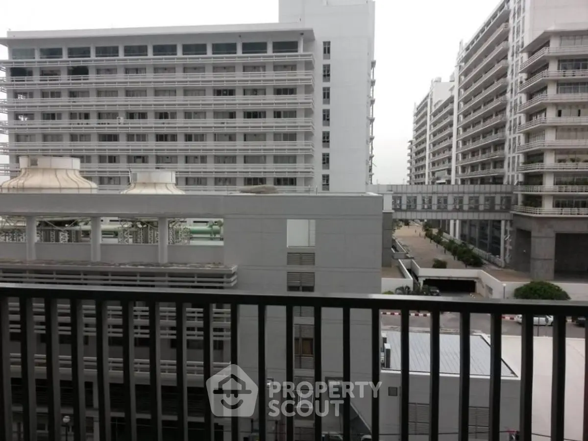 Modern urban apartment buildings with balconies and city view.