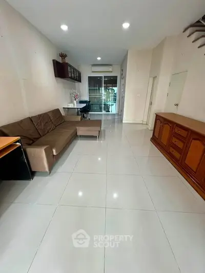 Spacious living room with modern furniture and sleek tile flooring