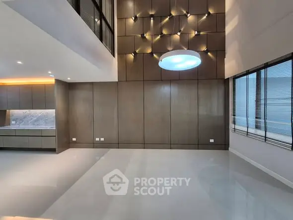 Spacious modern living room with high ceilings and elegant lighting