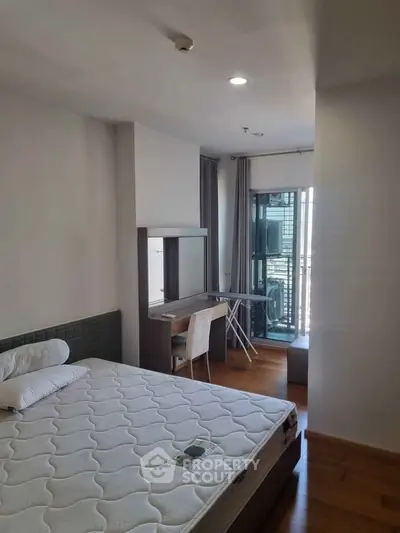 Modern bedroom with balcony view in urban apartment