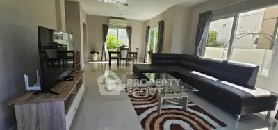 Spacious modern living room with large windows and sleek furniture