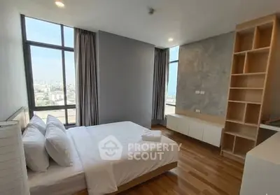 Spacious modern bedroom with large windows and city view