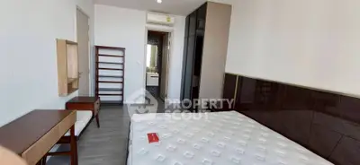 Modern bedroom with sleek furniture and air conditioning in a stylish apartment.