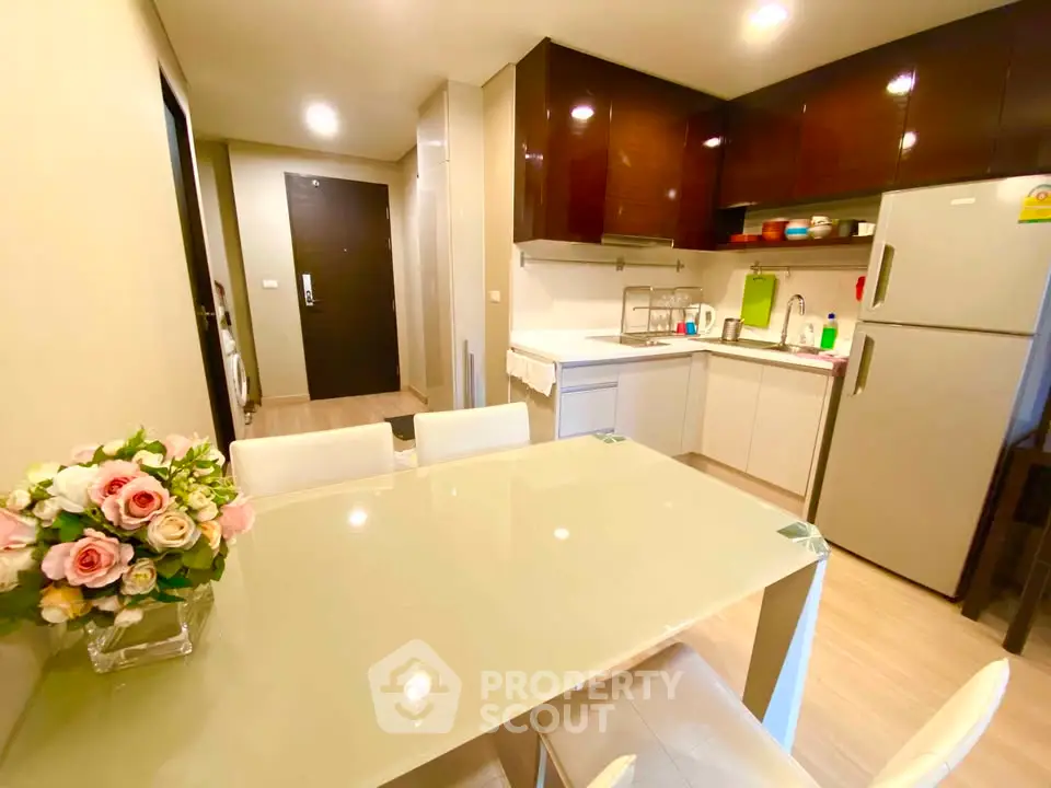 Modern kitchen with sleek cabinets and dining area in a cozy apartment