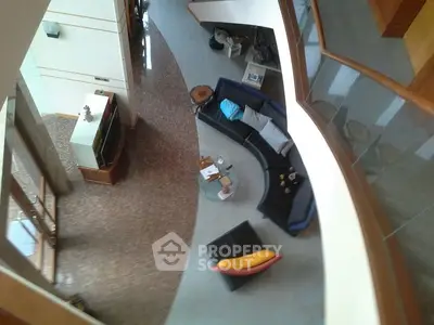 Spacious modern living room with unique curved sofa and stylish decor