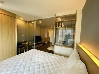 Modern bedroom with stylish decor and ample natural light in a contemporary apartment.