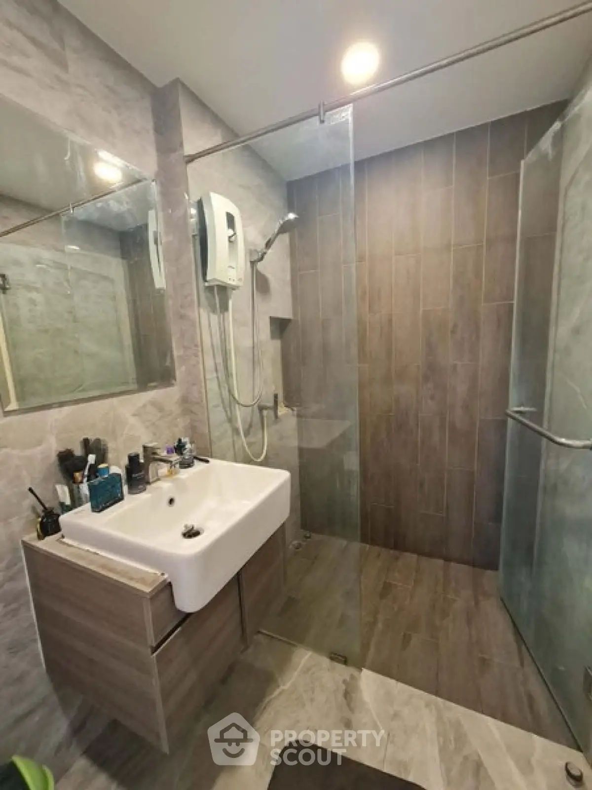 Modern bathroom with glass shower and sleek vanity in contemporary apartment