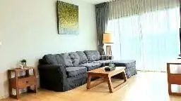 Spacious living room with modern decor and large window for natural light.