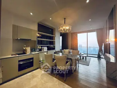 Luxurious open-plan living room with stunning city view and elegant chandelier.