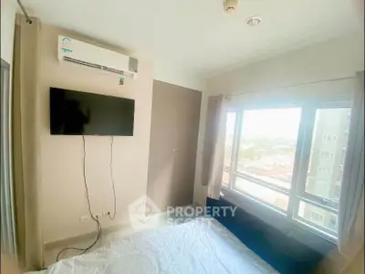 Bright bedroom with wall-mounted TV and large window view