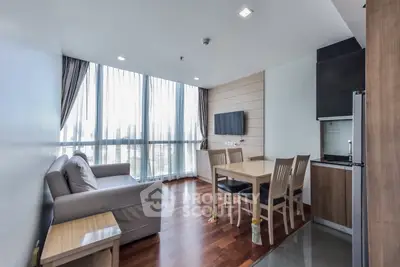 Modern living room with large windows, wooden flooring, and open kitchen layout in a stylish apartment.