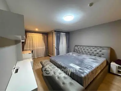 Spacious bedroom with elegant gray decor and large bed in modern apartment