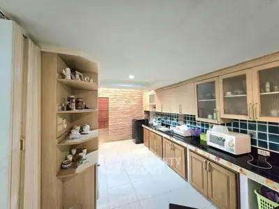 Spacious kitchen with modern appliances and ample storage in a stylish home.