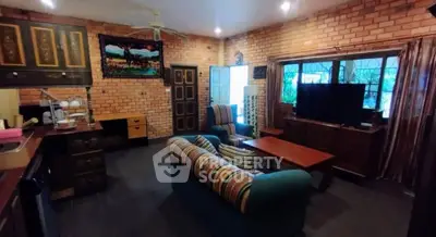 Charming rustic living room with exposed brick walls and cozy seating area.