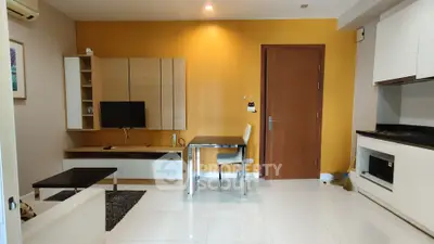 Modern living room with sleek furniture and vibrant yellow accent wall