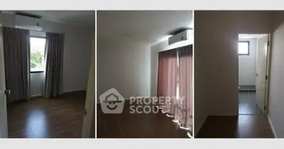 Spacious rooms with wooden flooring and large windows in a modern apartment.