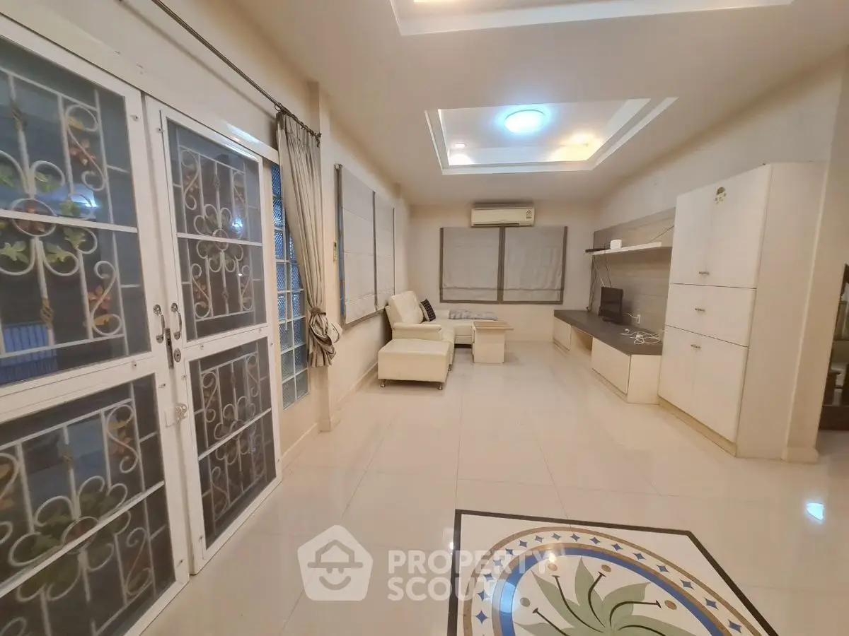 Spacious living room with modern decor and large windows