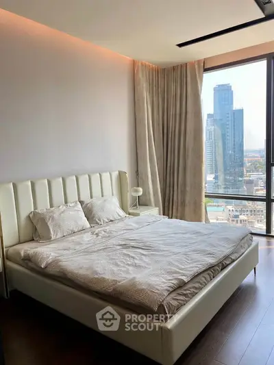 Luxurious bedroom with city view in modern high-rise apartment