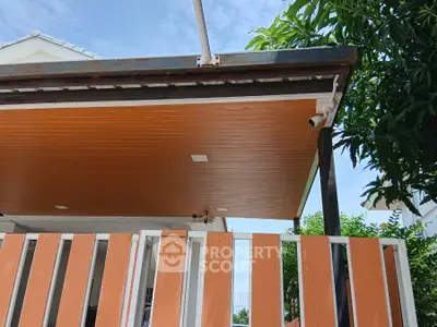 Modern house exterior with wooden paneling and security camera
